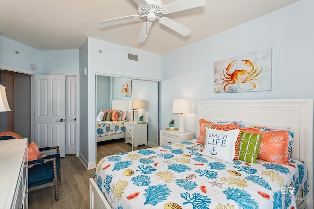 bedroom with ceiling fan, a closet, and dark wood-type flooring