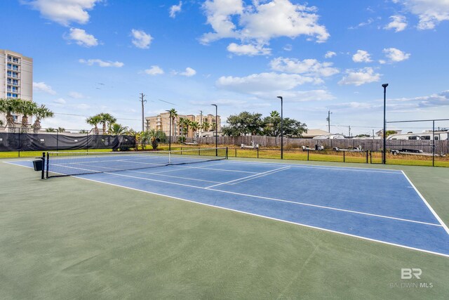 view of tennis court with basketball hoop