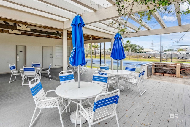 wooden deck with tennis court