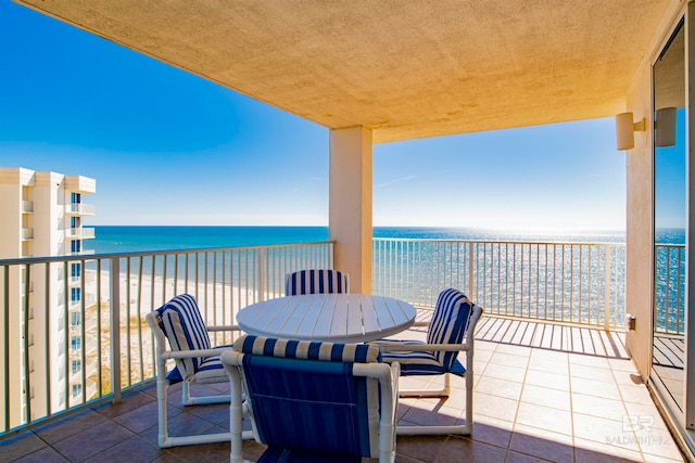 balcony with a beach view and a water view