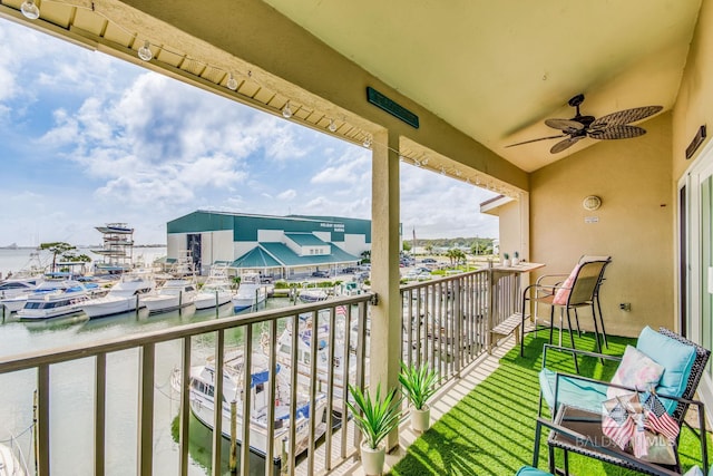 balcony with a water view and ceiling fan