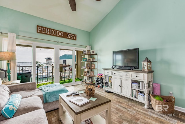 living room featuring high vaulted ceiling, wood-type flooring, and ceiling fan