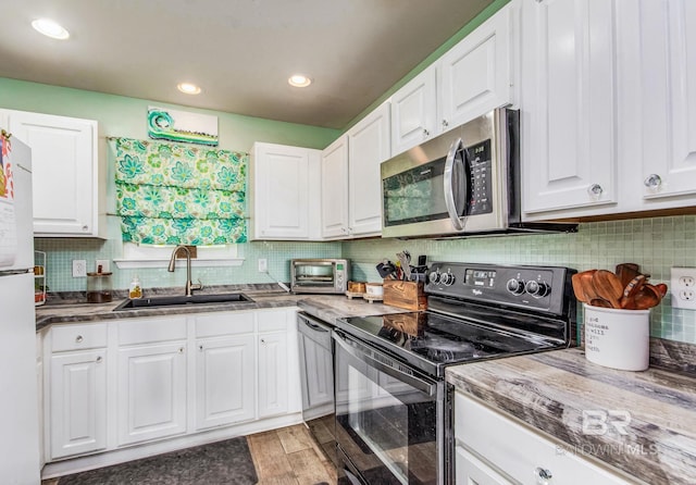 kitchen with white cabinets, tasteful backsplash, and stainless steel appliances