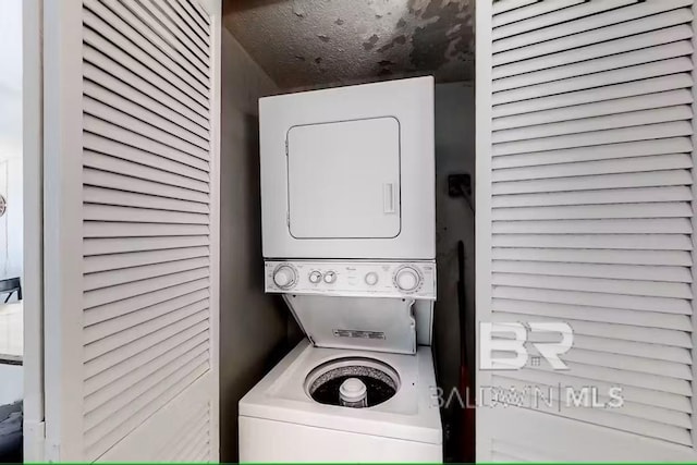 washroom featuring stacked washer and dryer