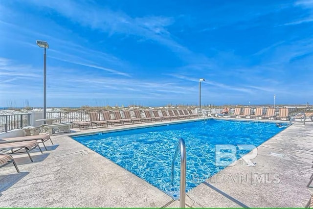 view of swimming pool featuring a patio area