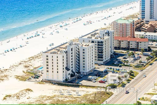 aerial view with a water view and a beach view