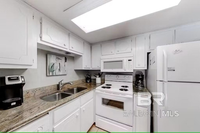 kitchen featuring white cabinetry, sink, light stone counters, and white appliances