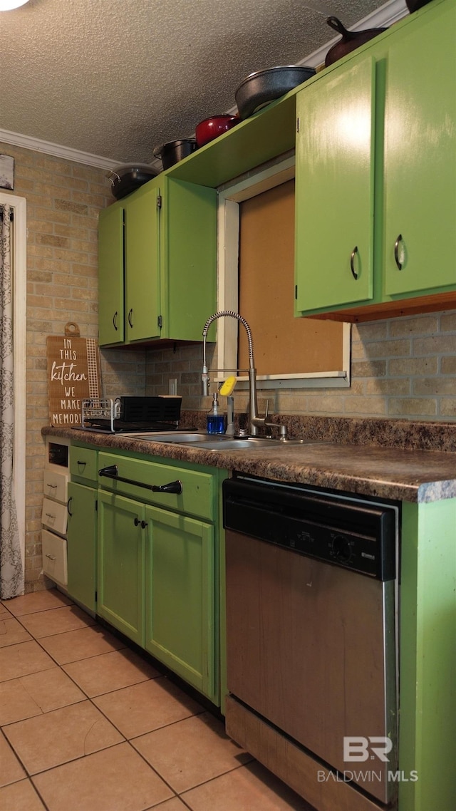 kitchen with a textured ceiling, crown molding, stainless steel dishwasher, light tile patterned floors, and brick wall