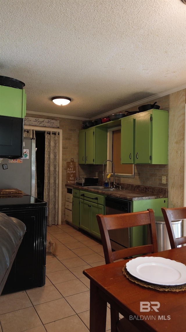 kitchen with a textured ceiling, crown molding, green cabinets, dishwasher, and light tile patterned floors