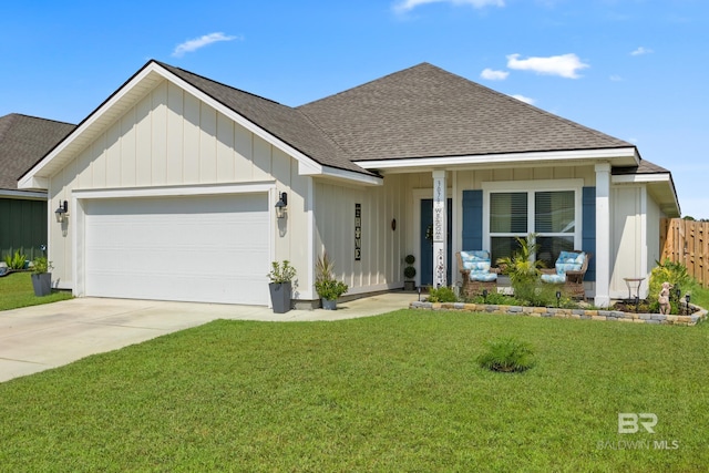 view of front of property featuring a garage and a front lawn