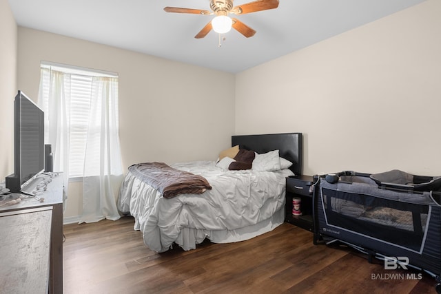 bedroom with dark hardwood / wood-style floors and ceiling fan