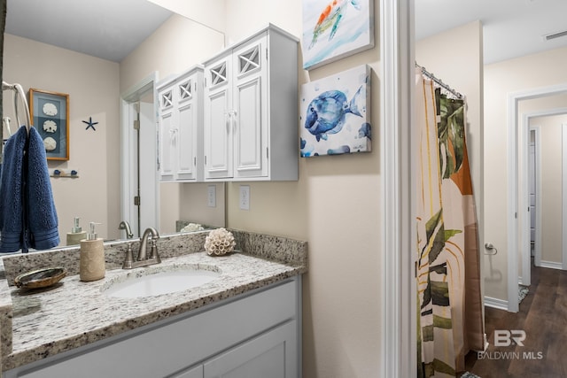 bathroom featuring vanity and wood-type flooring