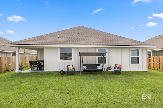 rear view of property featuring outdoor lounge area, a patio area, and a yard