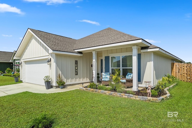 view of front of property with a front lawn, covered porch, and a garage