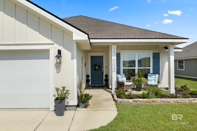 doorway to property featuring a lawn and a garage