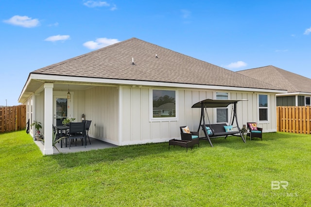 back of house featuring a yard and a patio