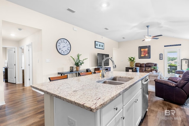 kitchen featuring light stone counters, ceiling fan, a kitchen island with sink, sink, and white cabinetry