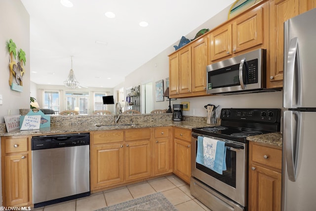 kitchen featuring light tile floors, light stone countertops, sink, and stainless steel appliances