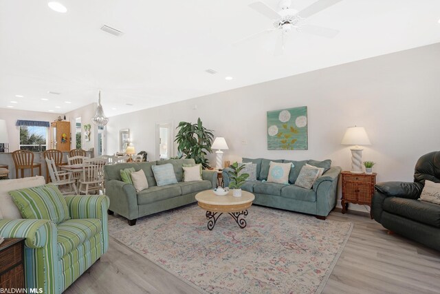 living room featuring ceiling fan and light hardwood / wood-style floors
