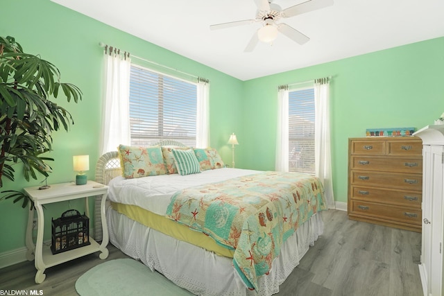 bedroom with ceiling fan and light hardwood / wood-style floors