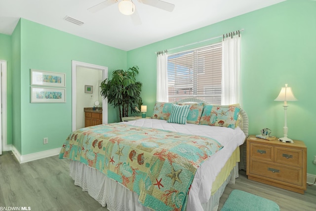 bedroom featuring ceiling fan, connected bathroom, and light hardwood / wood-style floors