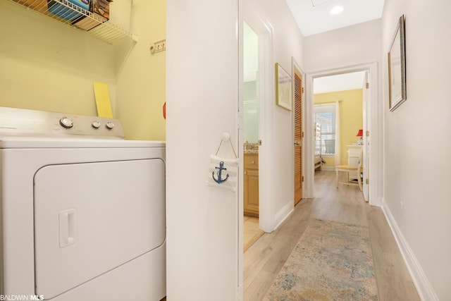 laundry area featuring washer / clothes dryer and light hardwood / wood-style floors