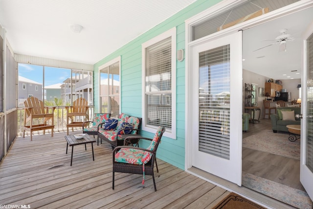 sunroom featuring ceiling fan