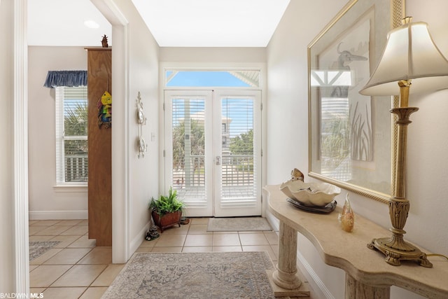 doorway featuring a healthy amount of sunlight, light tile floors, and french doors
