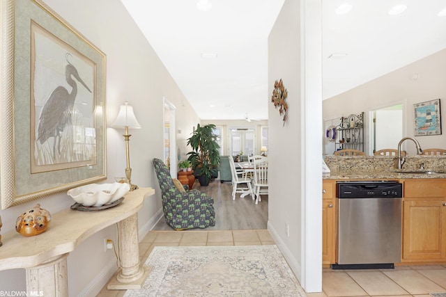 hallway featuring sink and light tile floors