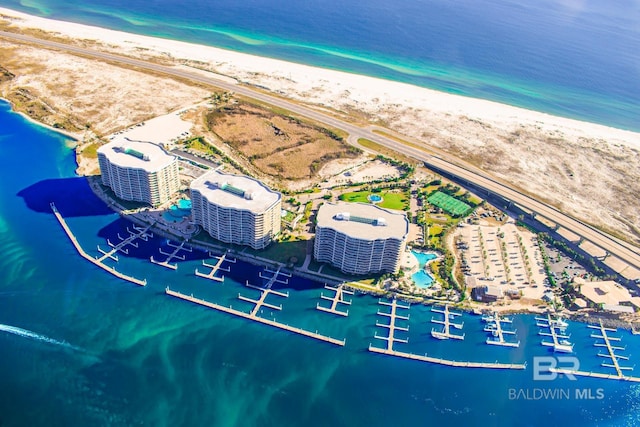 bird's eye view featuring a view of the beach and a water view