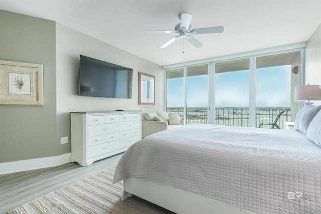 bedroom featuring access to exterior, ceiling fan, and light hardwood / wood-style flooring