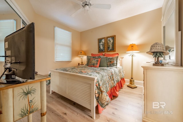 bedroom with light hardwood / wood-style floors and ceiling fan