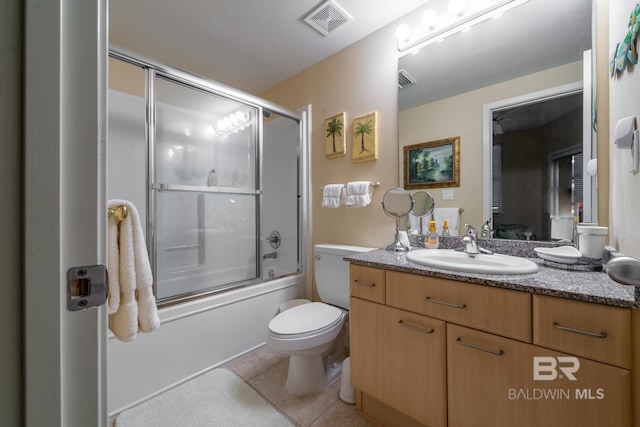 full bathroom featuring tile floors, bath / shower combo with glass door, vanity, and toilet