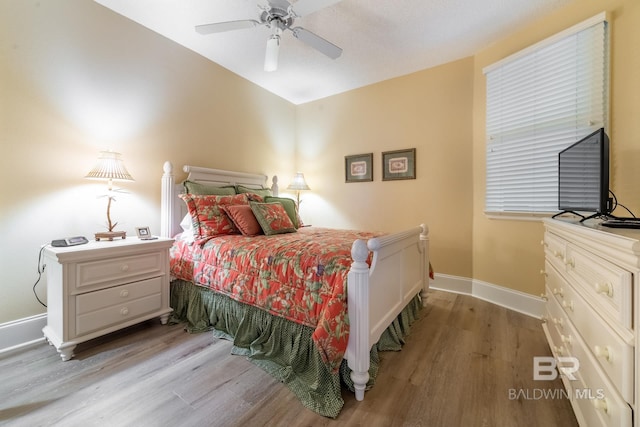 bedroom with wood-type flooring and ceiling fan