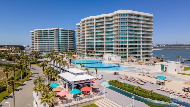 view of property with a water view and a community pool