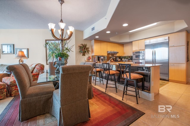 dining area with a notable chandelier and light tile floors