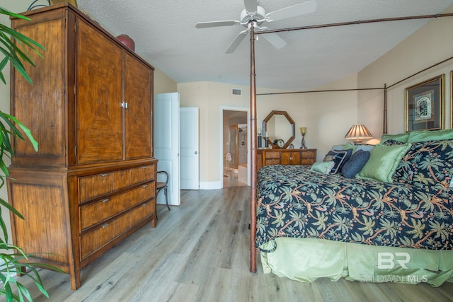 bedroom featuring ceiling fan, light hardwood / wood-style floors, and a textured ceiling