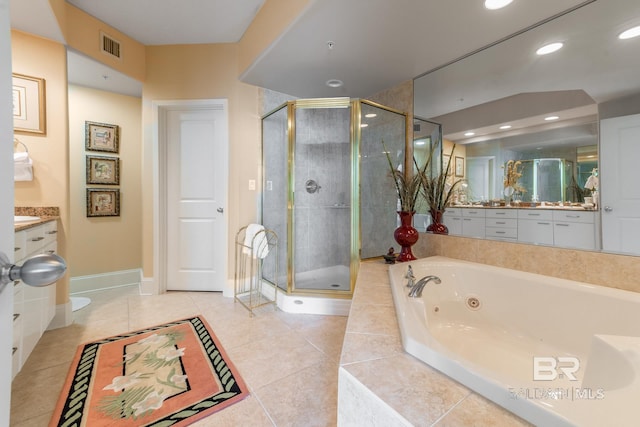 bathroom with tile flooring, separate shower and tub, and vanity