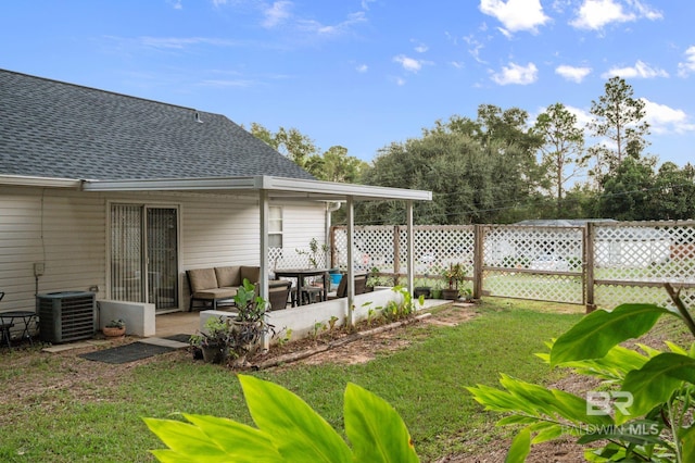 view of yard with outdoor lounge area, a patio area, and central AC unit