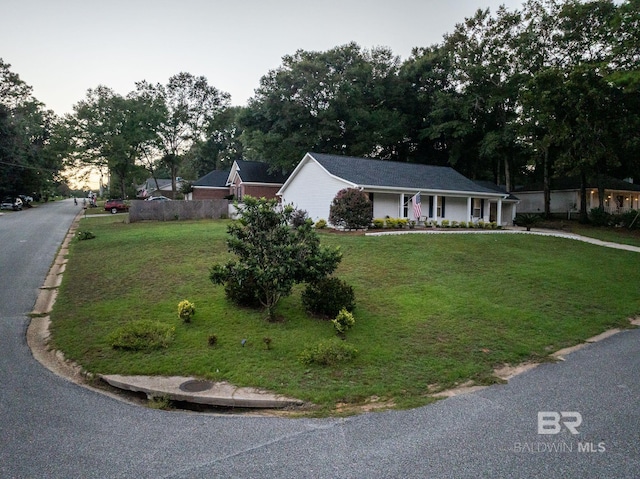 ranch-style house featuring a front lawn