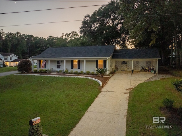 single story home featuring a porch and a lawn