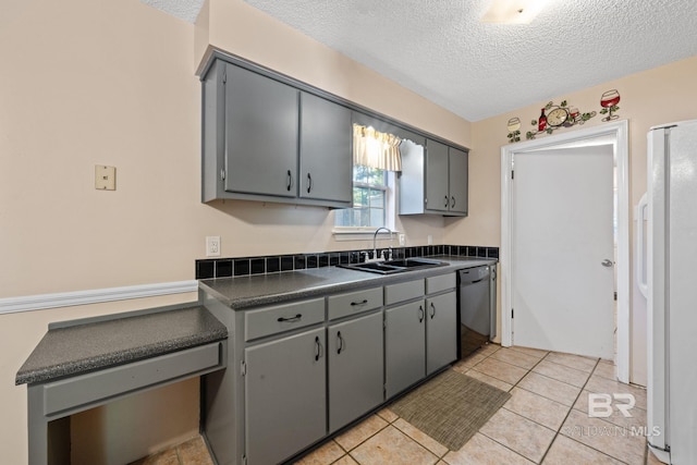 kitchen with gray cabinetry, white fridge with ice dispenser, dishwasher, sink, and a textured ceiling