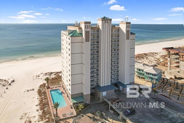 aerial view with a water view and a view of the beach