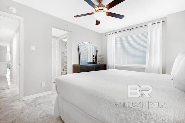 561 E Beach Blvd Unit 208, Gulf Shores, AL 36542 - bedroom featuring baseboards, ceiling fan, ensuite bath, and marble finish floor