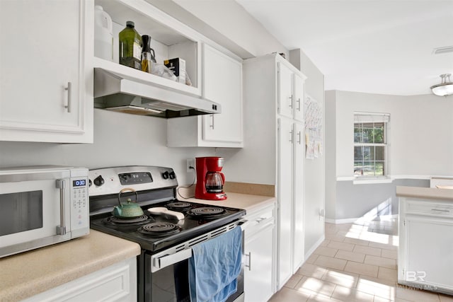 kitchen with white cabinetry, stainless steel range with electric stovetop, wall chimney exhaust hood, and light tile patterned floors