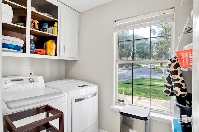 laundry room with independent washer and dryer and cabinets