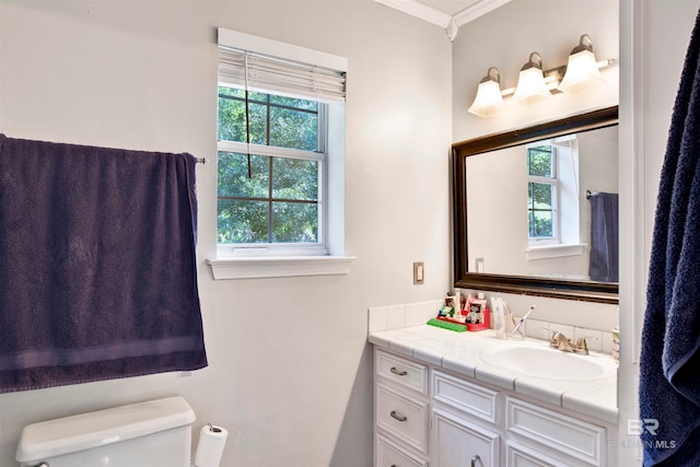 bathroom featuring crown molding, toilet, and vanity