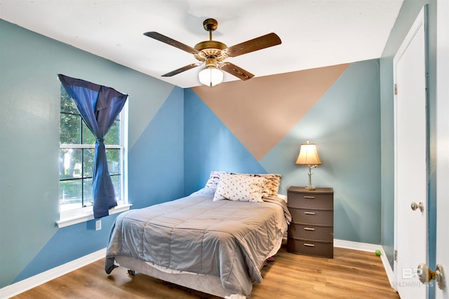 bedroom featuring hardwood / wood-style flooring and ceiling fan