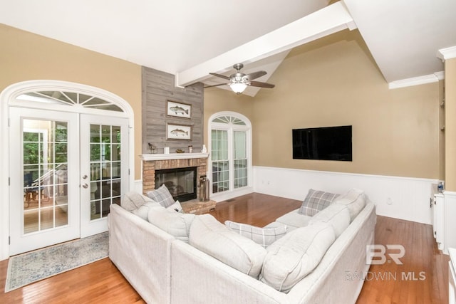 1509 Ridgeland Rd, Mobile, AL 36695 - living room with wainscoting, french doors, wood finished floors, a ceiling fan, and a fireplace