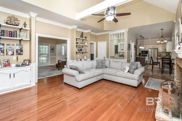 1509 Ridgeland Rd, Mobile, AL 36695 - living room featuring light wood finished floors, ceiling fan, crown molding, a chandelier, and a high ceiling